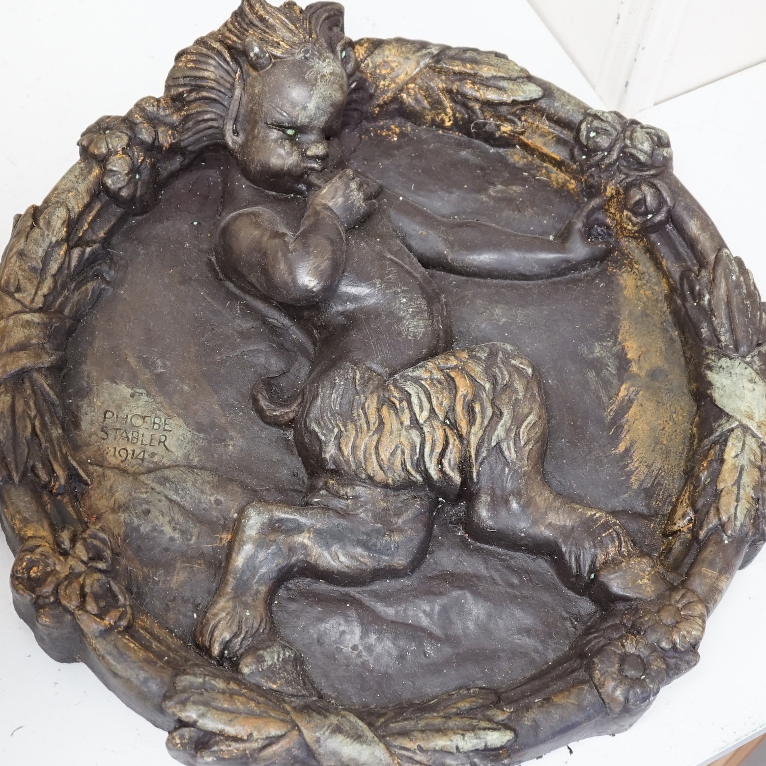 A reproduction Phoebe Stabler circular fawn plaque, 43cm diameter